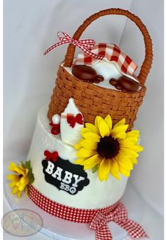 a cake made to look like a basket with sunflowers on top and the words baby