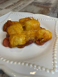 a white plate topped with food on top of a wooden table