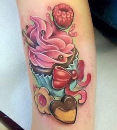 a cupcake with pink frosting and hearts on the side of her leg is shown