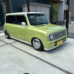 a green van parked in front of a building