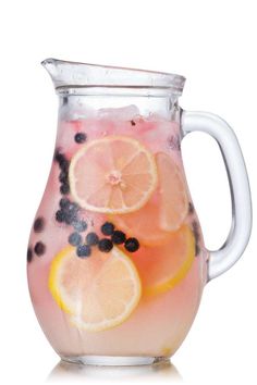 a pitcher filled with liquid and sliced lemons