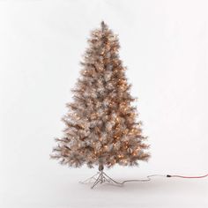 a white christmas tree with lights on it and a red cord attached to the base