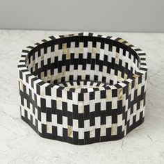 a black and white basket sitting on top of a table