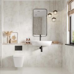 a bathroom with a toilet, sink and mirror on the wall next to each other