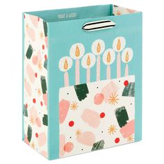 a birthday gift bag with candles on it