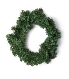 a christmas wreath with green needles on a white background, cut out into the shape of a circle