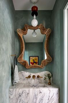 a bathroom with marble counter top and green walls