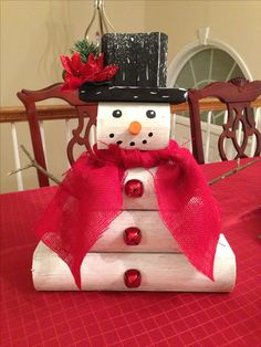 a snowman sitting on top of a red table