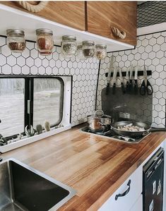 a kitchen with wooden counter tops and white walls