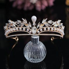 a tiara is sitting on top of a glass vase