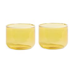 two yellow glass cups sitting next to each other