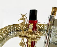 Vintage Gold Ormolu Nail Polish Holder and Stand.  This is a wonderful piece of 1970's Hollywood Regency Vanity Decor.  The nail polish holder features a "stand" for your finger, held by a golden sea horse.   The piece has a heavy size to weight ratio.  The nail polish space is approx 1" wide.  The entire piece is approximately 3" tall by 3" wide, 2 1/2" deep, and is in great condition.   Thank you and enjoy! Please see my other wonderful vintage decor at: https://www.etsy.com/shop/vintagemodernhip Refunds and Exchanges: I want you to be thrilled with your item.  I try to describe items through photography and words as accurately as possible.  I also try to research all items.  Please do not hesitate to contact me for any further information or pictures. Shipping Information: Please let me 1970s Hollywood, Nail Polish Holder, Vintage Nails, Vanity Decor, Gold Filigree, Hollywood Regency, Beautiful Furniture, Vintage Gold, Vintage Decor