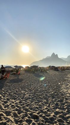 the sun shines brightly on a sandy beach