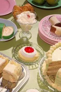 a table topped with lots of different types of cakes and desserts next to each other