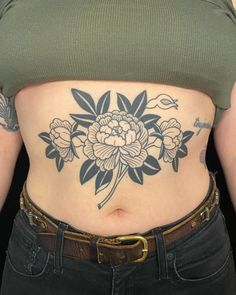 a woman's stomach with flowers on it, and the bottom half of her stomach is