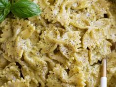 pasta with pesto sauce and basil on top