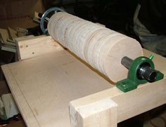 a piece of wood is being worked on with a circular vice and wooden planks