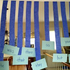 blue and white striped wall hanging with words that say,'hanging sight words as you are