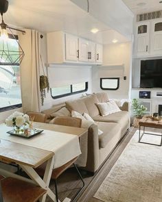 a living room filled with furniture and a flat screen tv mounted to the side of a wall