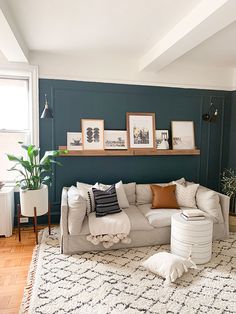 a living room filled with furniture and pictures on the wall