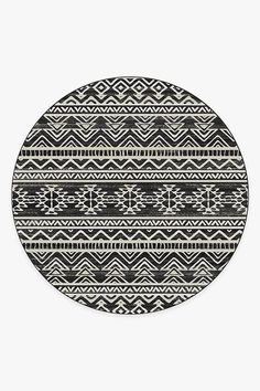 a black and white round rug with an abstract design