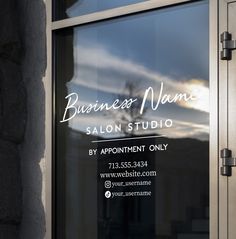 a glass window with the words business names on it and an image of a tree in the background