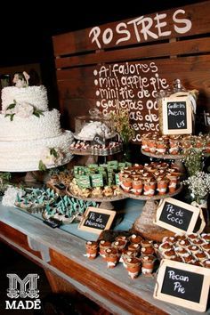 a table topped with lots of cakes and cupcakes on top of each other