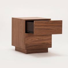 a small wooden table with drawers on one side and an open drawer on the other