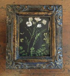 an old frame with flowers painted on it