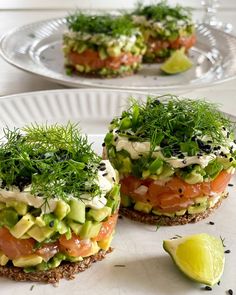 there are two sandwiches on the plate with some garnish and one is cut in half