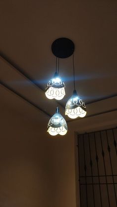 three lights hanging from the ceiling in a room