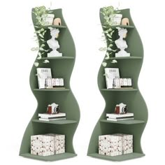 two green curved shelves with books and vases on each shelf, side by side