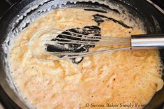 the food is being cooked in the pot with whisk attachments on top