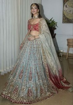 a woman in a blue and red lehenga