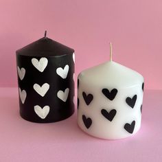 two black and white candles with hearts on them