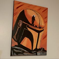 a painting of a boba fett helmet hanging on the wall