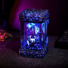 a purple and blue lamp sitting on top of a table