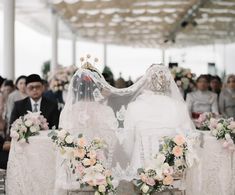 the bride and groom are sitting at their wedding ceremony