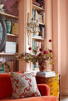 a living room filled with furniture and lots of books