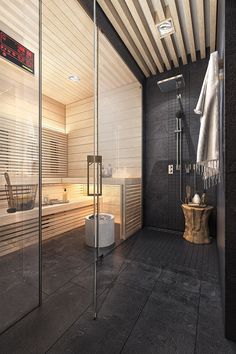 a bathroom with black tile and white walls, an open shower stall and wooden slatted ceiling