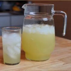 a pitcher and glass filled with ice on a table