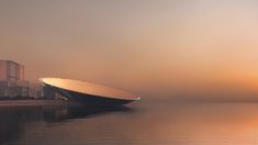 a large boat floating on top of a body of water next to a tall building