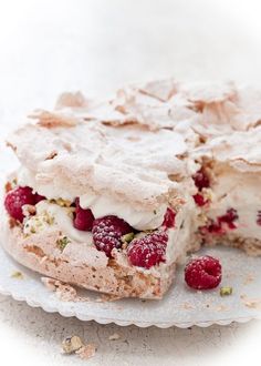 a dessert with raspberries and whipped cream on top