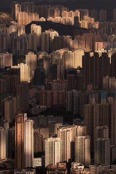 an aerial view of a city with high rise buildings and mountains in the back ground