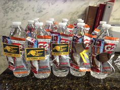 many bottles of water are lined up on the counter