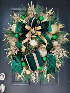 a christmas wreath with green and gold decorations