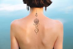 a woman with a lotus tattoo on her back