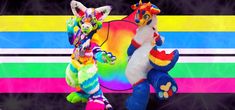 two stuffed animals standing next to each other in front of a rainbow striped wallpaper