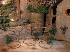 three metal planters sitting on top of a wooden table next to a christmas tree