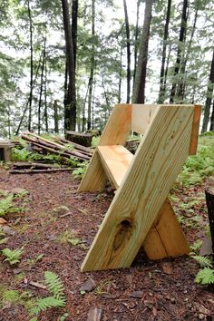 a wooden bench sitting in the middle of a forest